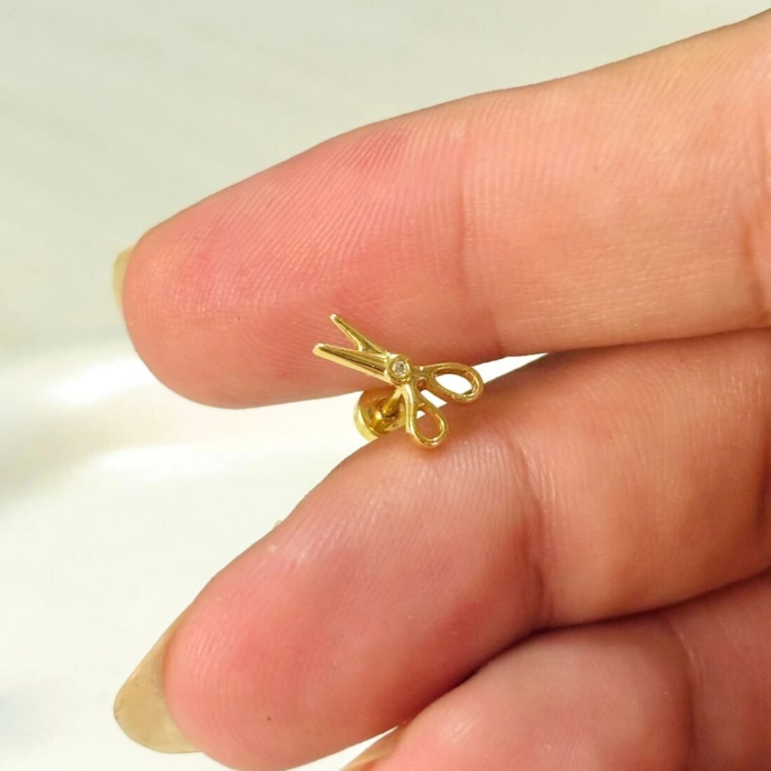 Tiny Snip Gold Ear Piercing